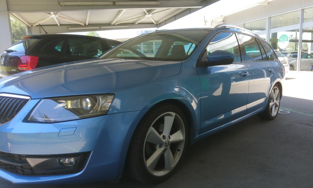 Picture depicts a sky blue Skoda Octavia (2014).